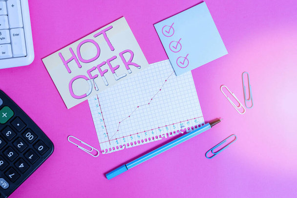 Text sign showing Hot Offer. Conceptual photo product or programme that is offered at reduced prices or rates Stationary and note paper plus math sheet with diagram picture on the table. - Fotoğraf, Görsel