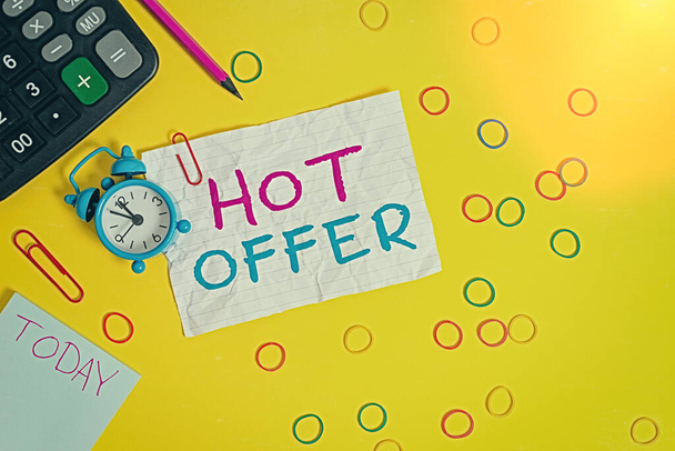Conceptual hand writing showing Hot Offer. Business photo text product or programme that is offered at reduced prices or rates Alarm clock note rubber bands calculator pencil colored background. - Photo, Image