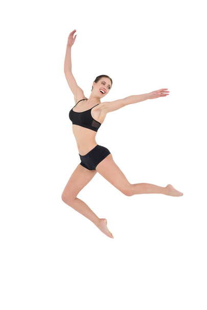 Sporty young woman jumping isolated on white background - Valokuva, kuva