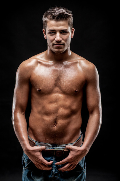 Young man on dark background - Foto, afbeelding