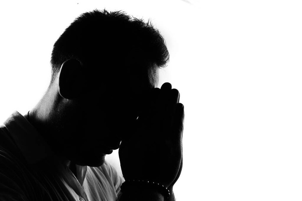 Modlitwa człowiek sylwetka, odizolowany na białym - Zdjęcie, obraz