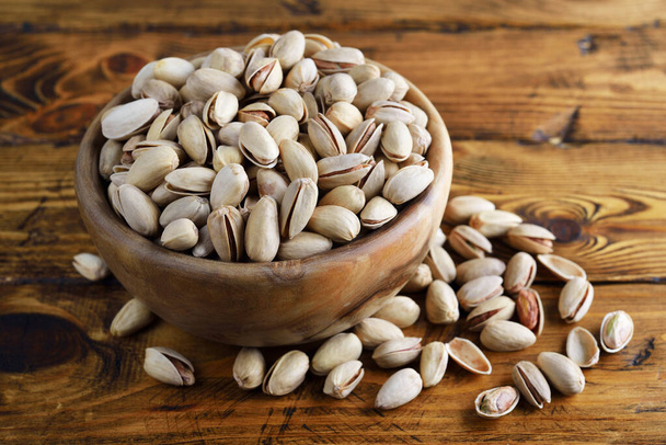 Organic pistachio nut on a brown background - Φωτογραφία, εικόνα