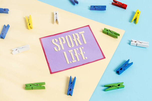 Handwriting text Sport Life. Concept meaning Fond of sports or other outdoor activities Physically active Colored clothespin paper empty reminder yellow blue floor background office. - Photo, Image