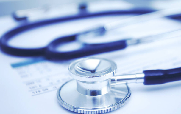 Medical equipment: blue stethoscope and tablet on white background. Medical equipment - Valokuva, kuva