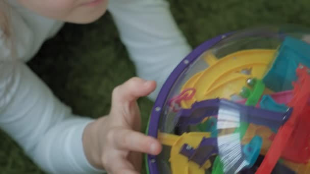Little girl play with three-dimensional toy puzzle - Záběry, video