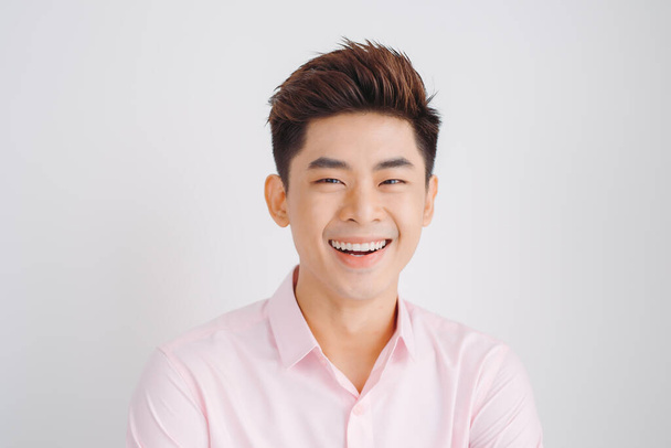 Smiling Asian man portrait over white background - Photo, Image