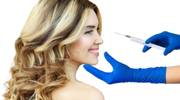 Beautiful woman gets an injection from surgeon. - Photo, Image