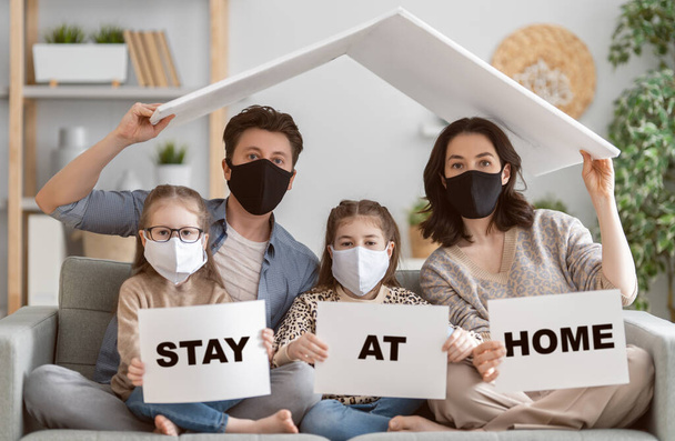 Family is wearing facemasks during coronavirus and flu outbreak. Virus and illness protection, quarantine. COVID-2019. A call to stay at home - Photo, image