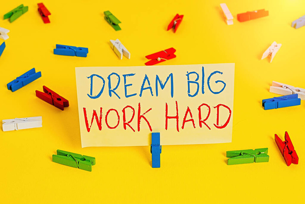 Word writing text Dream Big Work Hard. Business concept for Believe in yourself and follow the dreams and goals Colored clothespin papers empty reminder yellow floor background office. - Photo, Image