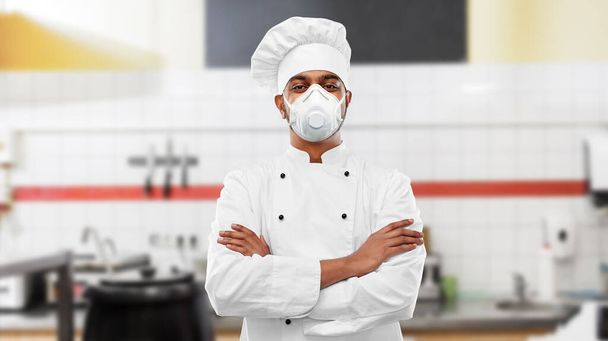 male chef in respirator at restaurant kitchen - Фото, изображение