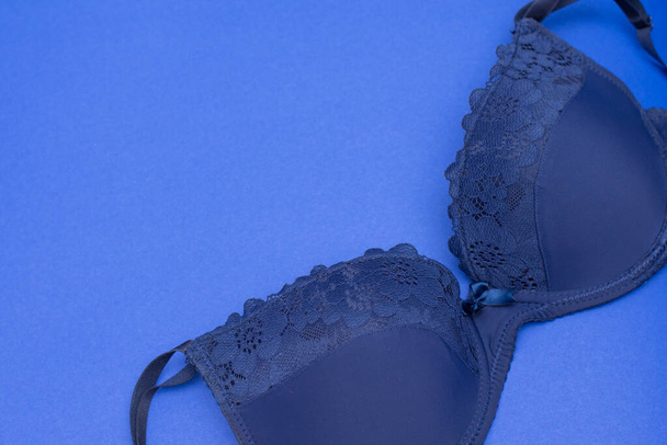 A classic blue bra close up on blue background. copy space - Φωτογραφία, εικόνα