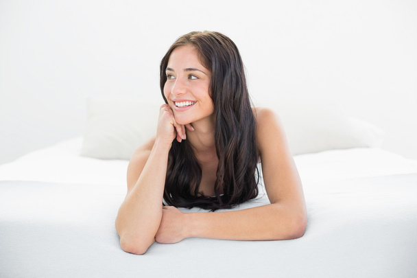 Happy woman looking away in bed - Photo, Image