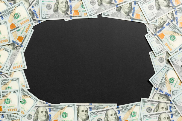 Frame of one hundred dollar bills with empty space for your design. Top view of business concept on black background with copy space. - Foto, Imagem