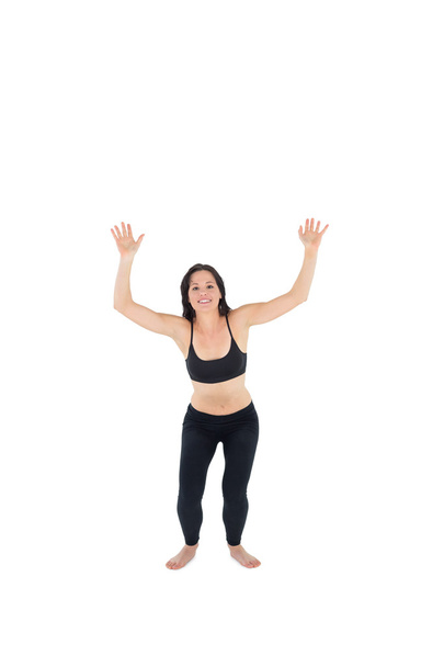 Sporty young woman about to jump over white background - Photo, image