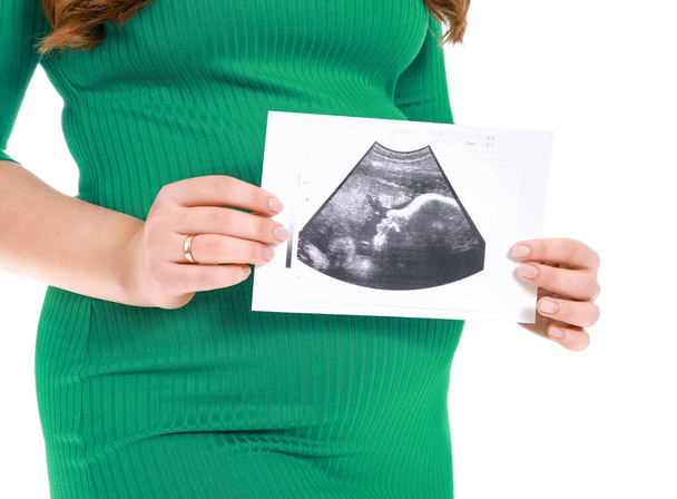 Beautiful pregnant woman with sonogram image on white background, closeup - Photo, Image