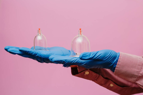 Vacuum pumps and jars for hijama. Arms. On a pink background - Fotografie, Obrázek