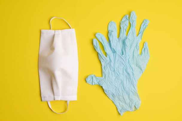 protective masks and disposable latex gloves on a colored surface - Fotografie, Obrázek