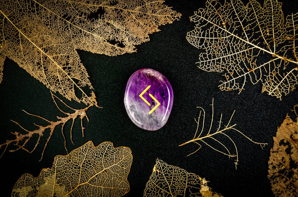 Jeraz (Jera) rune made of natural amethyst and skeletons of leaves - Photo, Image