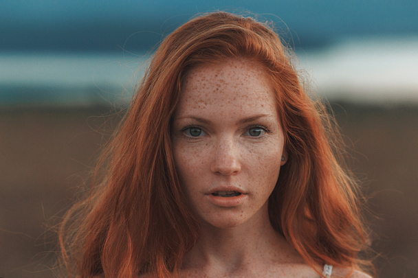Positive natural close up portrait of young gorgeous caucasian ginger girl with freckles. Healthy lifestyle, beauty, natural concept. Melancholic beautiful portrait - Photo, Image