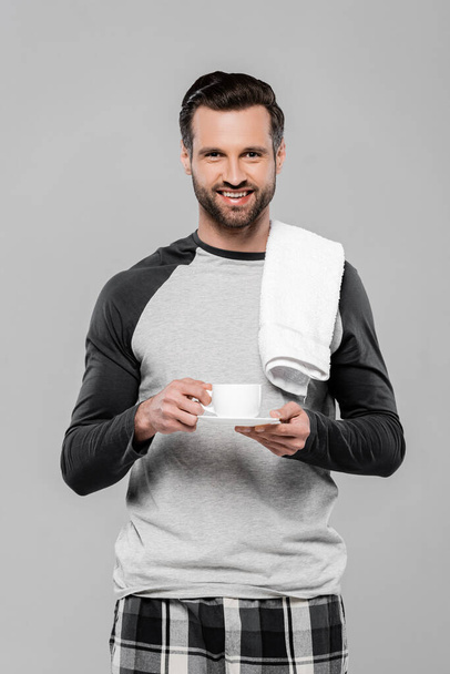 cheerful bearded man holding cup of coffee isolated on grey - Zdjęcie, obraz