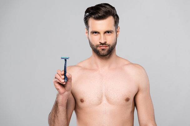muscular and handsome man holding razor isolated on grey  - Zdjęcie, obraz