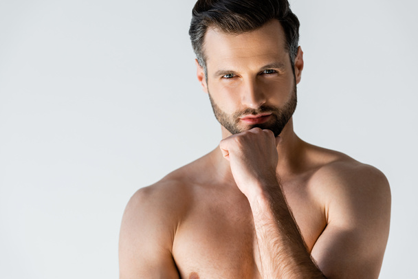 pensive and shirtless man touching face and thinking isolated on white  - Fotó, kép