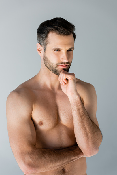 thoughtful and shirtless man touching face isolated on grey  - Foto, Bild
