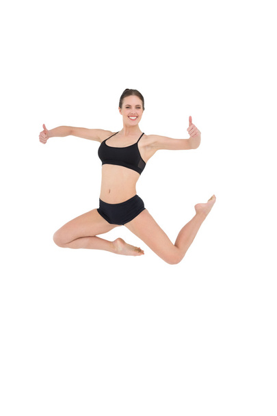 Sporty woman jumping isolated on white background - Zdjęcie, obraz