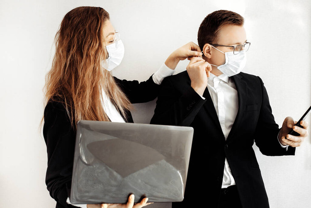 Young business people wearing face masks  with laptop and smartphone  - Photo, Image