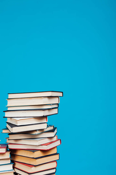 many stacks of books to teach in the library on a blue background - 写真・画像