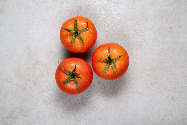 Fresh red tomatoes on a gray stone. Background, illustration for advertising, recipes or cookbook. - Foto, immagini