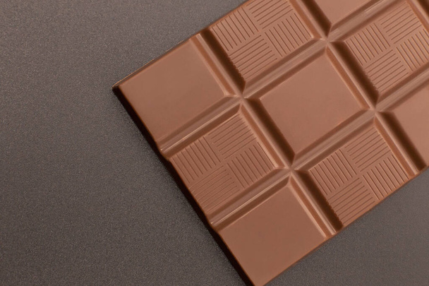 Chocolate bar. Chocolate on a dark background. - Фото, изображение