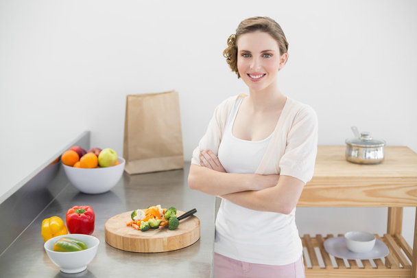 Brunette woman posing in kitchen with arms crossed in her kitche - Photo, Image