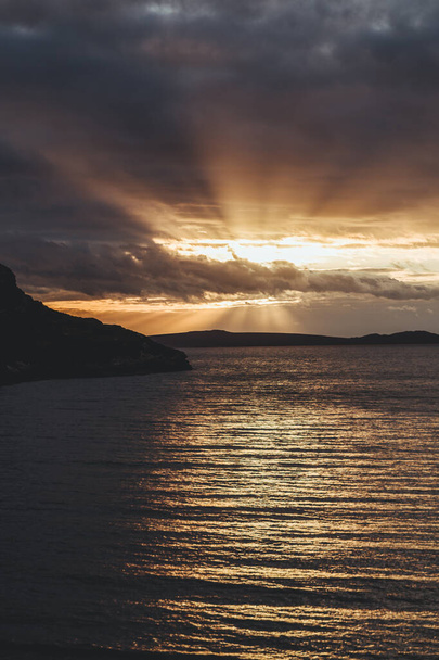 The scenic sunset over the Ardmair Bay of Loch Kanaird. Ardmair is a village in Wester Ross, in the North West Highlands of Scotland, located 3 miles north of Ullapool. It is a popular holiday resort - 写真・画像