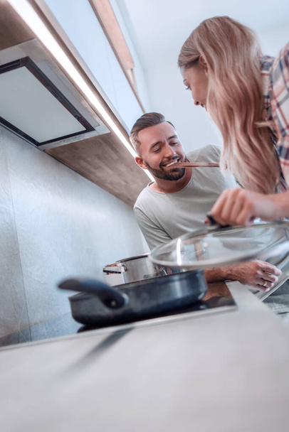 young husband and wife cook dinner together - Photo, image