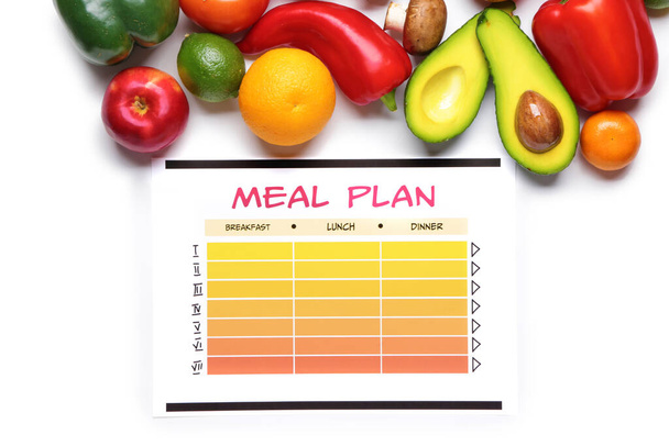 Produtos saudáveis e plano de refeições sobre fundo branco
 - Foto, Imagem