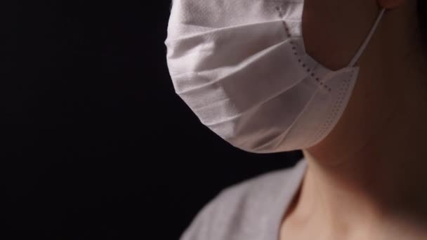 sick young woman in protective face mask praying - Záběry, video