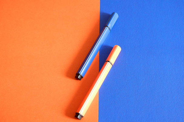 Colored markers on an orange-blue background - Фото, изображение