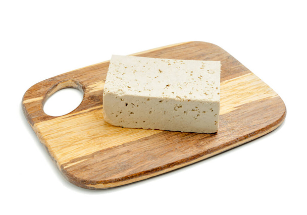 Board with tasty tofu cheese on white background - Photo, Image