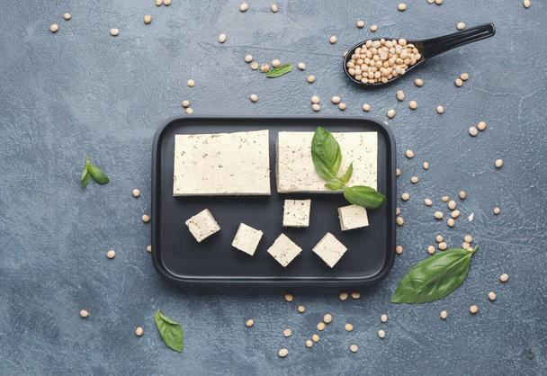 Plate with tasty tofu cheese on dark background - Photo, Image