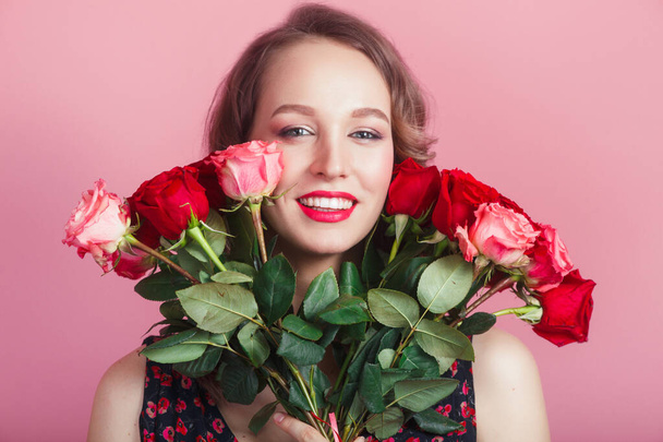 Close-up portrait of smiling cute attractive charming brunette lady hiding behind colorful flowers on pink background - Fotografie, Obrázek