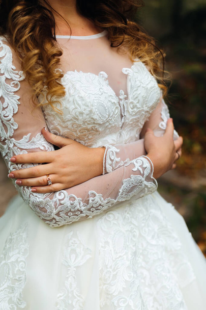 close-up of wedding dress on the bride who embrace himself - Photo, Image