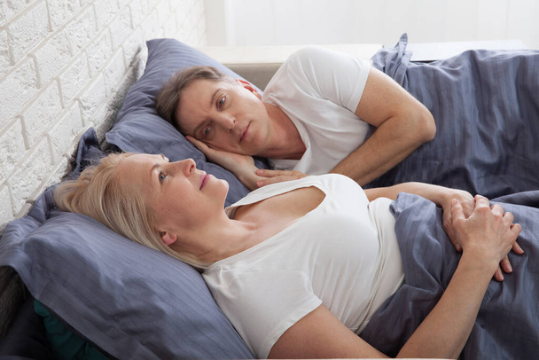 Unhappy middle aged couple in bedroom at home - Foto, Imagem