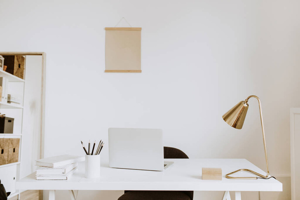 Modern minimal interior design concept. Bright Scandinavian home office desk table workspace with laptop, lamp, books. Business study cabinet. Girl boss studio concept. - Φωτογραφία, εικόνα