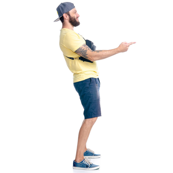 Man in shorts and cap standing happiness smiling showing pointing - Foto, Imagem