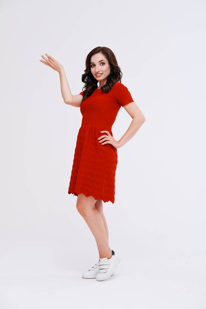 portrait of woman in red dress with raised arms - Foto, afbeelding