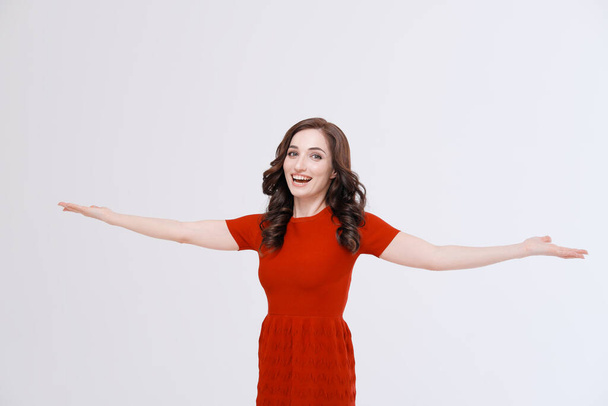 portrait of woman in red dress with raised arms - Photo, image