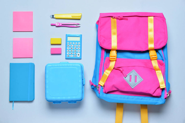 School backpack and stationery on light background - Photo, Image