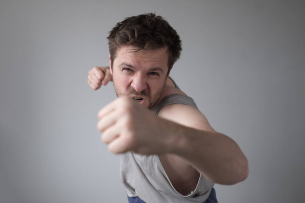 aggressive man showing his fist. Domestic violence and harassment during staying home - Photo, Image