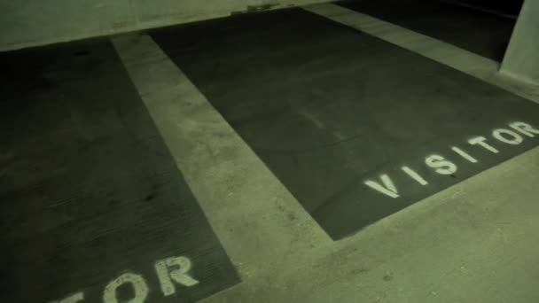 Empty visitors parking spots in an underground parking garage - Footage, Video